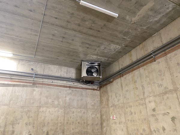 Fan coil mounted in a concrete-walled cold room